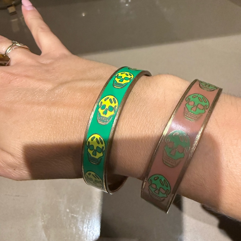 Vintage Alexandr McQueen bangles. Goldtone and enamel skull bangles